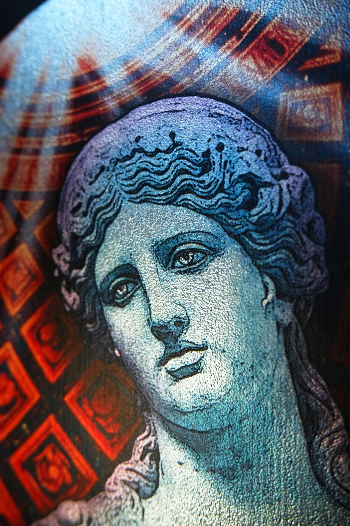 A close-up of a classical-style bust portrait with a blue-toned face and hair, layered over a red and dark patterned background.dark academia decor Melpomene
Muse of Tragedy