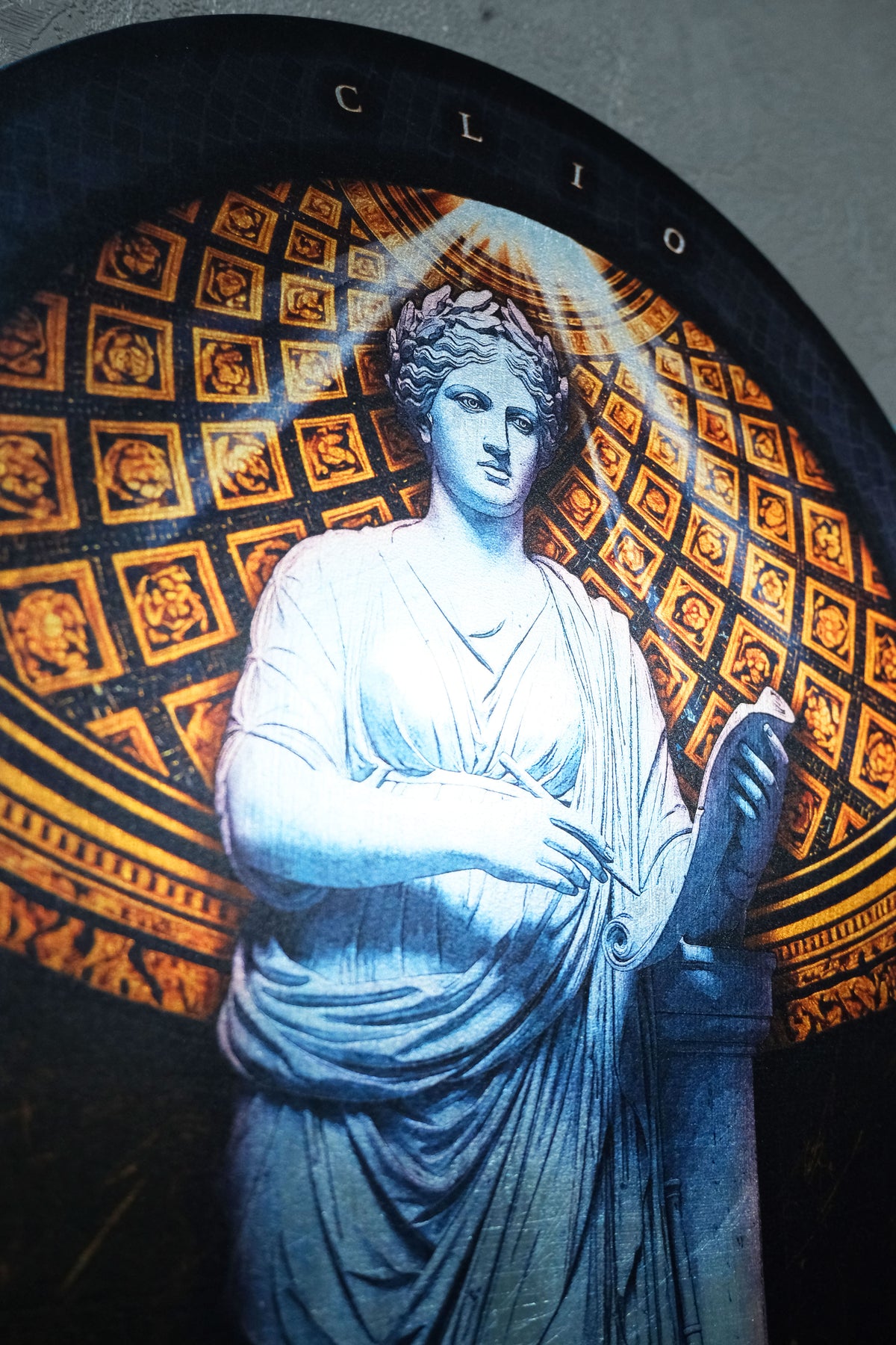 A close-up of a decorative wall art piece featuring a classical female statue in white drapery, set against a black and gold patterned background with the word 'CLIO' at the top. dark academia decor Clio — Muse of History