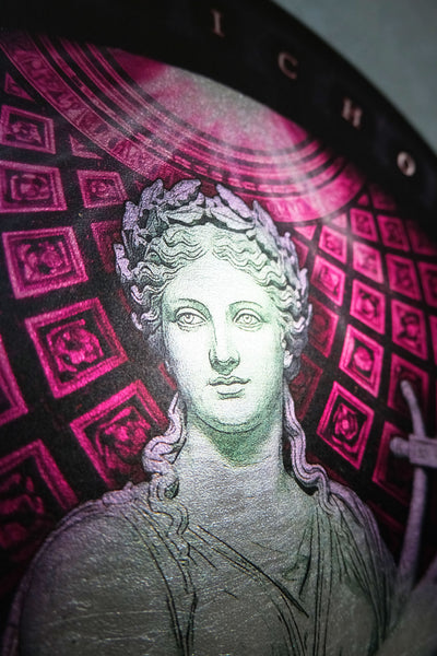 A close-up of a circular decorative plaque or print featuring a classical female bust in pale green-gray tones, set against a dark background with bright pink geometric patterns and partial lettering at the top.  dark academia decor  Terpsichore — Muse of Dance