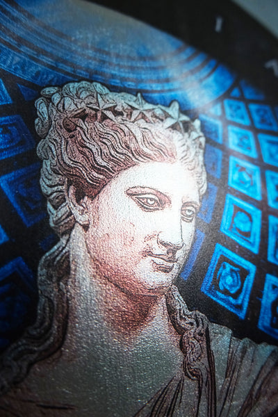 Close-up of a classical-style portrait artwork showing part of a woman's face and upper torso, rendered in blue, black, gray, and beige tones against a patterned background. Urania is the Greek Muse of astronomy and astrology