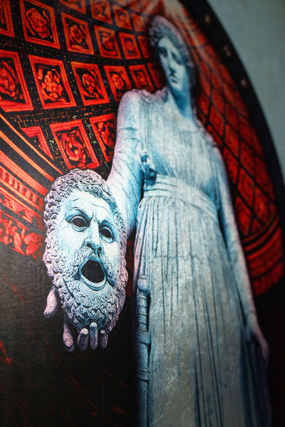 A close-up of a dark artwork featuring a pale blue-gray classical female statue holding a severed, screaming human head, set against a red patterned background. dark academia decor  Melpomene
Muse of Tragedy