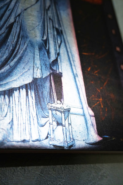 A close-up of a printed artwork or poster showing a draped figure in pale blue-gray tones beside a small pedestal, with dark shadowy areas and orange highlights. dark academia decor  Clio — Muse of History