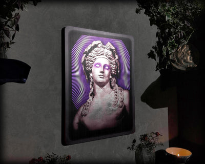 Decorative wall art with a stylized portrait in a frame on a dark background
"Dionysus silver leaf wall art with purple glow accents in dark modern frame"